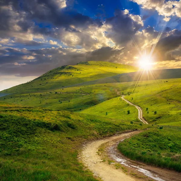 Calm sunlit walking path stretching gently through soft countryside